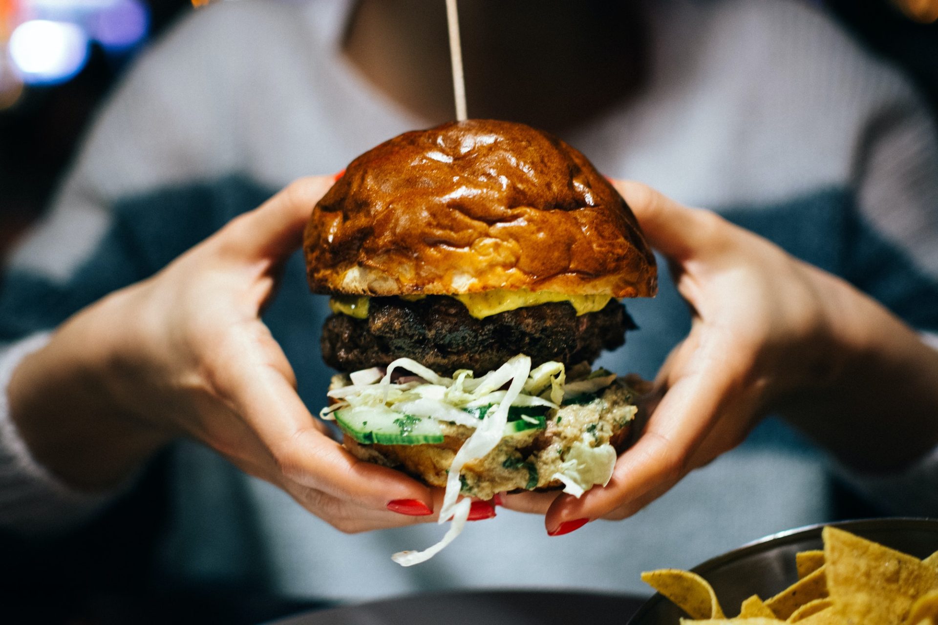 Celebrating with a juicy beef burger in a restaurant